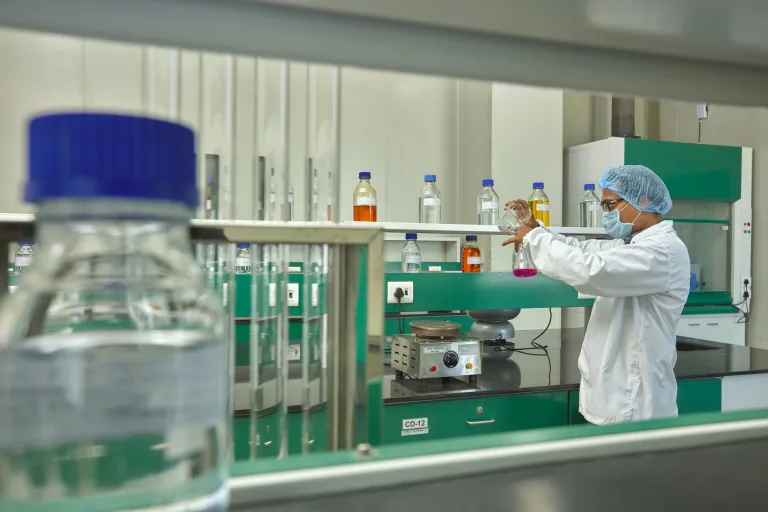 Chemist checking a sample flask in the quality control laboratory